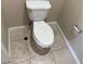 Top down view of a standard toilet with matching tile flooring at 10118 Farmington Hall Ct, Las Vegas, NV 89129