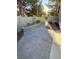 Landscaped backyard with a garden bed and paved walkway at 10321 Birch Bluff Ln, Las Vegas, NV 89145