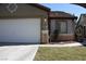 Exterior view of home with a two-car garage and well-maintained lawn at 10321 Birch Bluff Ln, Las Vegas, NV 89145