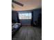 Bedroom featuring wood-look flooring and a large window, creating a bright and airy atmosphere at 105 Huntly Rd, Las Vegas, NV 89145