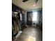 View of the bedroom with black wardrobe, and a window with dark curtains at 105 Huntly Rd, Las Vegas, NV 89145