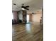 Living room showcasing a stone fireplace, wood-look flooring, and two ceiling fans at 105 Huntly Rd, Las Vegas, NV 89145