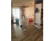 View of living room with wood-look flooring and access to outdoor patio and backyard at 105 Huntly Rd, Las Vegas, NV 89145