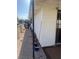 View of side yard area with gravel, privacy fence, and access door to the home at 105 Huntly Rd, Las Vegas, NV 89145