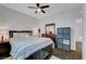 Bedroom featuring a large bed, dark wood floors, dresser, and streamlined storage solutions at 1120 Via Della Curia, Henderson, NV 89011