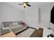 Bright bedroom featuring a ceiling fan, modern gray daybed, and ample closet space at 1120 Via Della Curia, Henderson, NV 89011