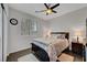 Cozy bedroom showcasing wood-look tile, plantation shutters, and a comfortable queen-sized bed at 1120 Via Della Curia, Henderson, NV 89011