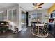 Bright dining area with wood floors, black table and chairs, and access to the backyard at 1120 Via Della Curia, Henderson, NV 89011