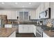 Modern kitchen featuring stainless steel appliances, granite countertops, tile backsplash, and white cabinetry at 1120 Via Della Curia, Henderson, NV 89011