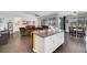 Bright kitchen with granite counters, white cabinets, seamlessly connecting the living room and dining area at 1120 Via Della Curia, Henderson, NV 89011