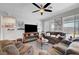 Spacious living room with plush seating, ceiling fan, and ample natural light at 1120 Via Della Curia, Henderson, NV 89011