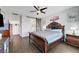 Bedroom boasting a stylish bed, dark wood floors, and a sliding barn door to the bathroom at 1120 Via Della Curia, Henderson, NV 89011