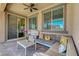 Outdoor patio featuring stylish seating under a covered area, with a view of backyard at 1120 Via Della Curia, Henderson, NV 89011