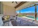 Inviting covered patio with comfortable seating, a ceiling fan, and a view of the pool and backyard at 1120 Via Della Curia, Henderson, NV 89011