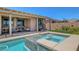 Gorgeous backyard oasis featuring a sparkling pool and spa with a covered patio area at 1120 Via Della Curia, Henderson, NV 89011