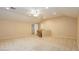 A bonus room features neutral carpeting, recessed lighting, and an open layout leading to the stairwell at 11204 Newbury Hills Ave, Las Vegas, NV 89138