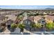 An aerial view of a two-story home with a well-manicured front lawn and an attached two-car garage at 1266 Smokey Valley Ln, Henderson, NV 89002