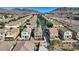 An aerial view of a two-story home, well-kept neighborhood and stunning mountain backdrop at 1266 Smokey Valley Ln, Henderson, NV 89002