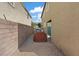 Narrow backyard patio, fully gravelled, with privacy walls on both sides at 1266 Smokey Valley Ln, Henderson, NV 89002