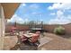 A backyard with a patio featuring outdoor seating and a trampoline on a gravel lot at 1266 Smokey Valley Ln, Henderson, NV 89002