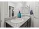 Bright bathroom featuring dual sinks, granite countertops, and modern fixtures at 1266 Smokey Valley Ln, Henderson, NV 89002