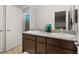 Bright bathroom with dual sinks, granite countertops, and wood cabinetry offering a blend of style and functionality at 1266 Smokey Valley Ln, Henderson, NV 89002