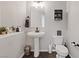 Elegant half bathroom featuring a pedestal sink, modern fixtures, and neutral decor for a clean and functional space at 1266 Smokey Valley Ln, Henderson, NV 89002