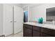 Bathroom showcasing double sinks with granite countertops and dark wood cabinets at 1266 Smokey Valley Ln, Henderson, NV 89002