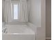 A bathtub with a frosted window, offering privacy and light at 1266 Smokey Valley Ln, Henderson, NV 89002