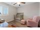 Bedroom with a crib, soft lighting and seating, creating a serene atmosphere for comfort and care at 1266 Smokey Valley Ln, Henderson, NV 89002