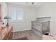 Charming Bedroom with wood floors, a crib, a dresser and a window with shutter blinds at 1266 Smokey Valley Ln, Henderson, NV 89002