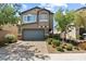 Charming two-story home with a brick driveway and lush landscaping in a quiet neighborhood at 1266 Smokey Valley Ln, Henderson, NV 89002