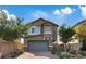 Charming two-story home features a well-manicured lawn and an attached two-car garage, perfect for Gathering living at 1266 Smokey Valley Ln, Henderson, NV 89002