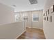 Upstairs hallway featuring wood floors, natural light, and minimalist wall decor at 1266 Smokey Valley Ln, Henderson, NV 89002