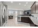 Open-concept kitchen featuring stainless steel appliances, granite countertops, and backyard access at 1266 Smokey Valley Ln, Henderson, NV 89002