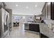 Spacious open-concept kitchen with an island that flows into a dining and living area filled with natural light at 1266 Smokey Valley Ln, Henderson, NV 89002