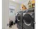 Bright laundry room with modern front-loading washer and dryer, plus a window for natural light at 1266 Smokey Valley Ln, Henderson, NV 89002