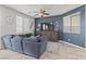 Cozy living room with a dark accent wall and comfortable sectional sofa at 1266 Smokey Valley Ln, Henderson, NV 89002