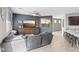 Comfortable living room with a plush gray sectional, media center, and a ceiling fan for relaxed living at 1266 Smokey Valley Ln, Henderson, NV 89002