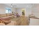 Spacious living room featuring wood floors, a ceiling fan, and ample natural light at 1266 Smokey Valley Ln, Henderson, NV 89002