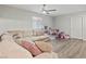 Comfortable living room with a plush sectional, ceiling fan and plenty of natural light at 1266 Smokey Valley Ln, Henderson, NV 89002