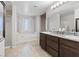 Bathroom featuring a separate shower and tub, plus a dual vanity sink at 1266 Smokey Valley Ln, Henderson, NV 89002