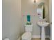 Cozy half-bathroom featuring a pedestal sink, toilet, and neutral color palette at 150 Las Vegas Blvd # 2115, Las Vegas, NV 89101