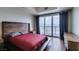Bright bedroom boasts hardwood floors, wood-paneled headboard, and large windows showcasing city views at 150 Las Vegas Blvd # 2115, Las Vegas, NV 89101