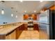 Modern kitchen with stainless steel appliances, wood cabinets, and granite countertops at 150 Las Vegas Blvd # 2115, Las Vegas, NV 89101