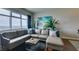 Comfortable living room featuring a gray leather sectional couch, and bright artwork with large window at 150 Las Vegas Blvd # 2115, Las Vegas, NV 89101