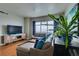 Bright living room with hardwood floors, stylish seating, and large windows overlooking the city at 150 Las Vegas Blvd # 2115, Las Vegas, NV 89101