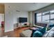 Comfortable living room featuring hardwood floors, modern decor, and a large window with city skyline view at 150 Las Vegas Blvd # 2115, Las Vegas, NV 89101