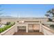 Rooftop outdoor kitchen featuring built-in stainless grill and bar fridge with desert views at 150 Las Vegas Blvd # 2115, Las Vegas, NV 89101