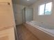 Modern bathroom features a soaking tub, shower, and tile flooring at 165 W Alma Ave, Overton, NV 89040